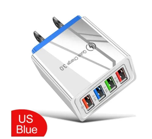 Compact 4-port USB mobile phone charger in multiple colours, shown plugged into a UK wall socket.