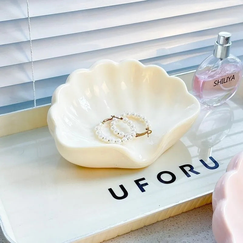 Shell-shaped white plastic soap dish with drainage for bathroom use