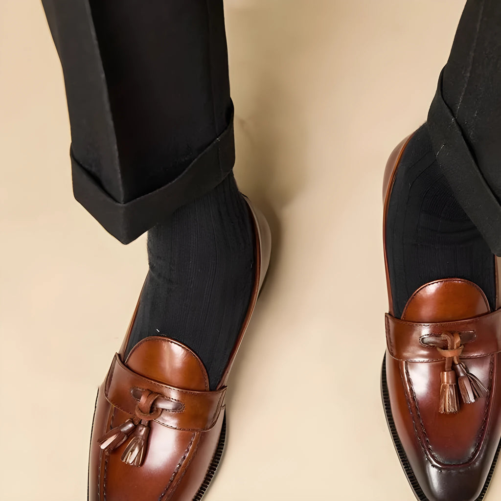 Men's genuine leather tassel loafers in black and brown colours showing polished upper and rubber sole