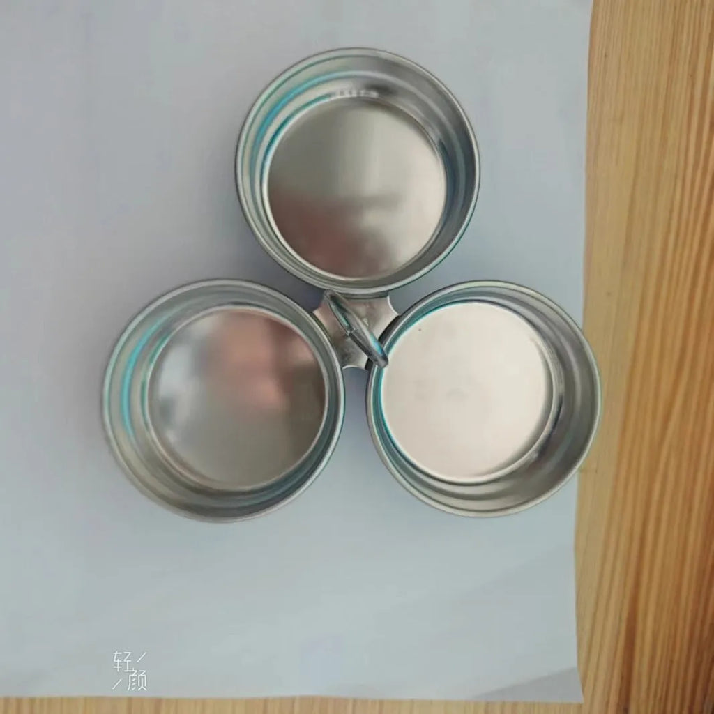 Stainless steel heart-shaped egg steamer for boiling eggs on kitchen counter.