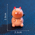 Eight small resin and plastic capybara figurines with different Halloween-themed designs.