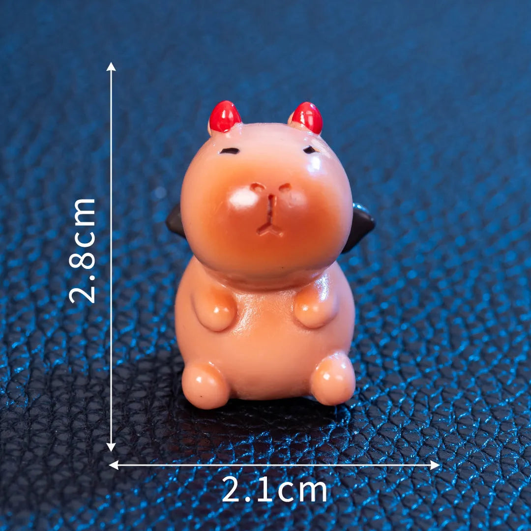 Eight small resin and plastic capybara figurines with different Halloween-themed designs.