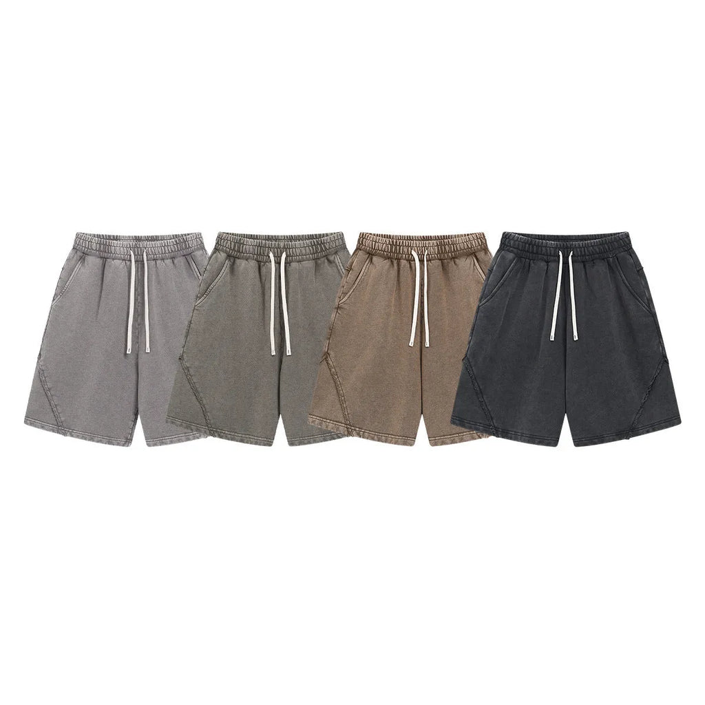 Men's loose-fit cotton terry shorts in batik colours on a size chart background.
