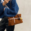 One-shoulder underarm tote bag in PU with polyester lining, zip coin pocket, and splicing detail.
