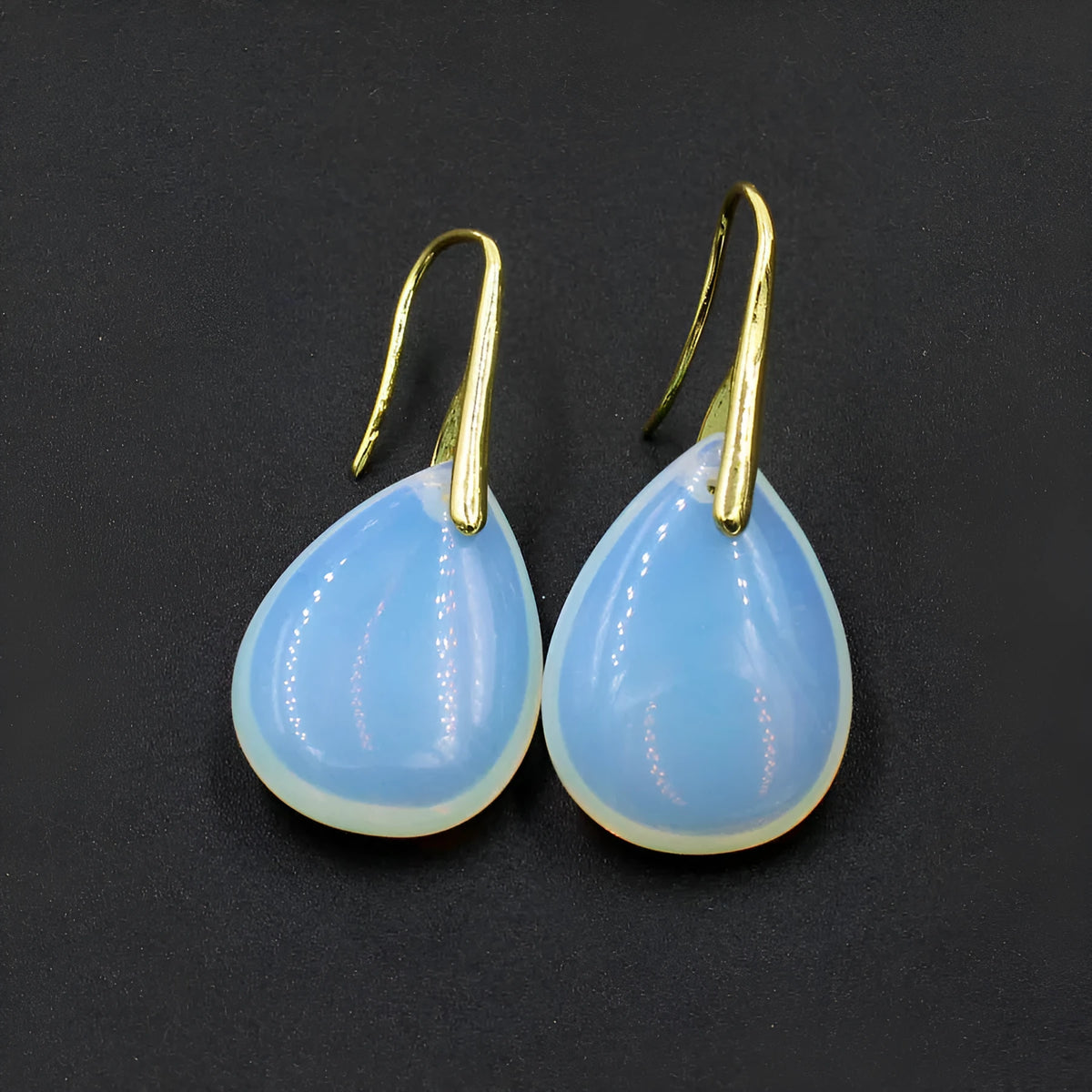 Geometric water drop crystal earrings with electroplated metal setting in various stone colours.