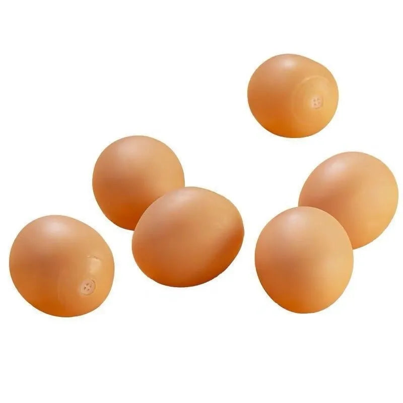 Yellow egg-shaped dog teeth cleaning toy with textured rubber surface for dental care