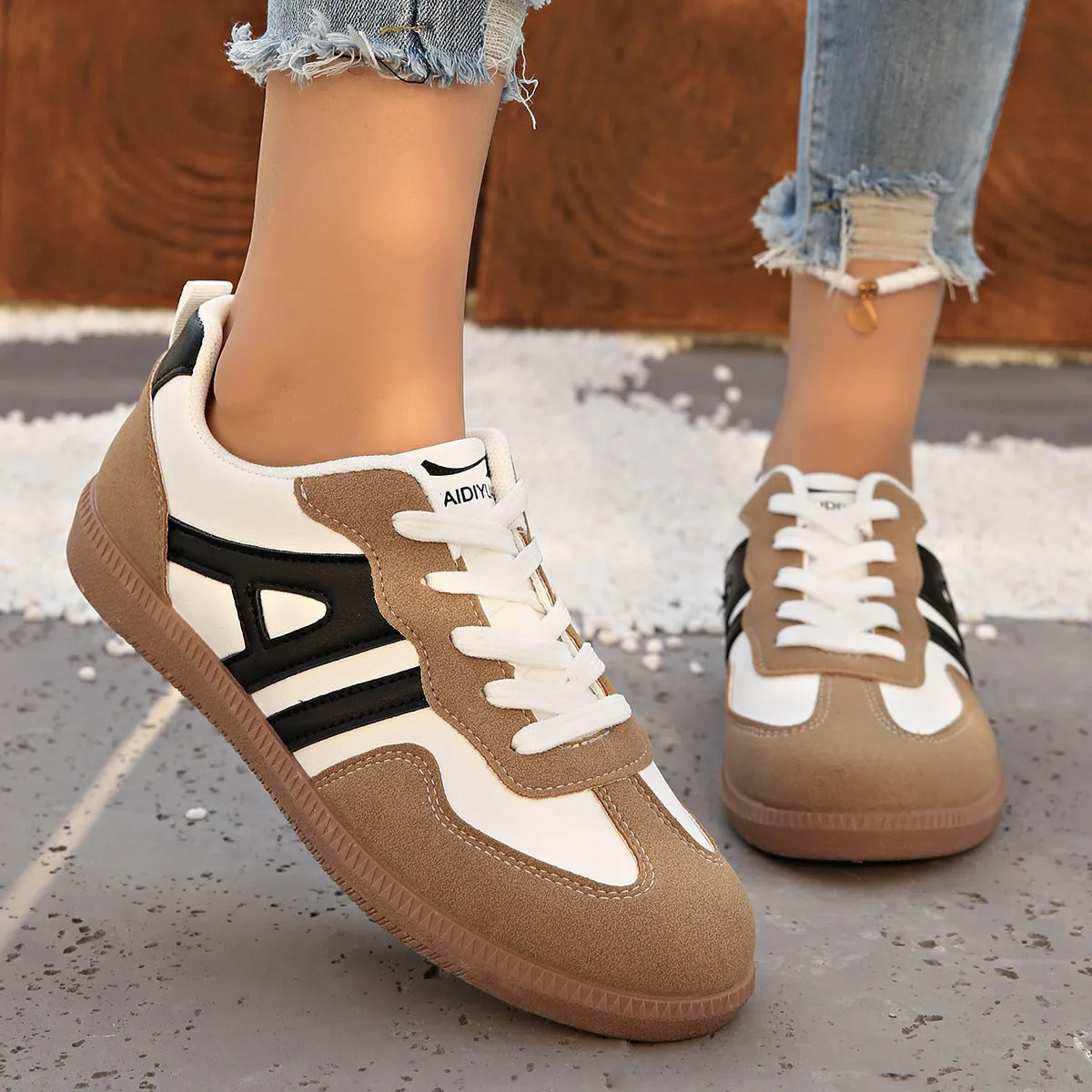 Women's retro lace-up jogging shoes in black, grey, and khaki colours showing round toe and platform heel.