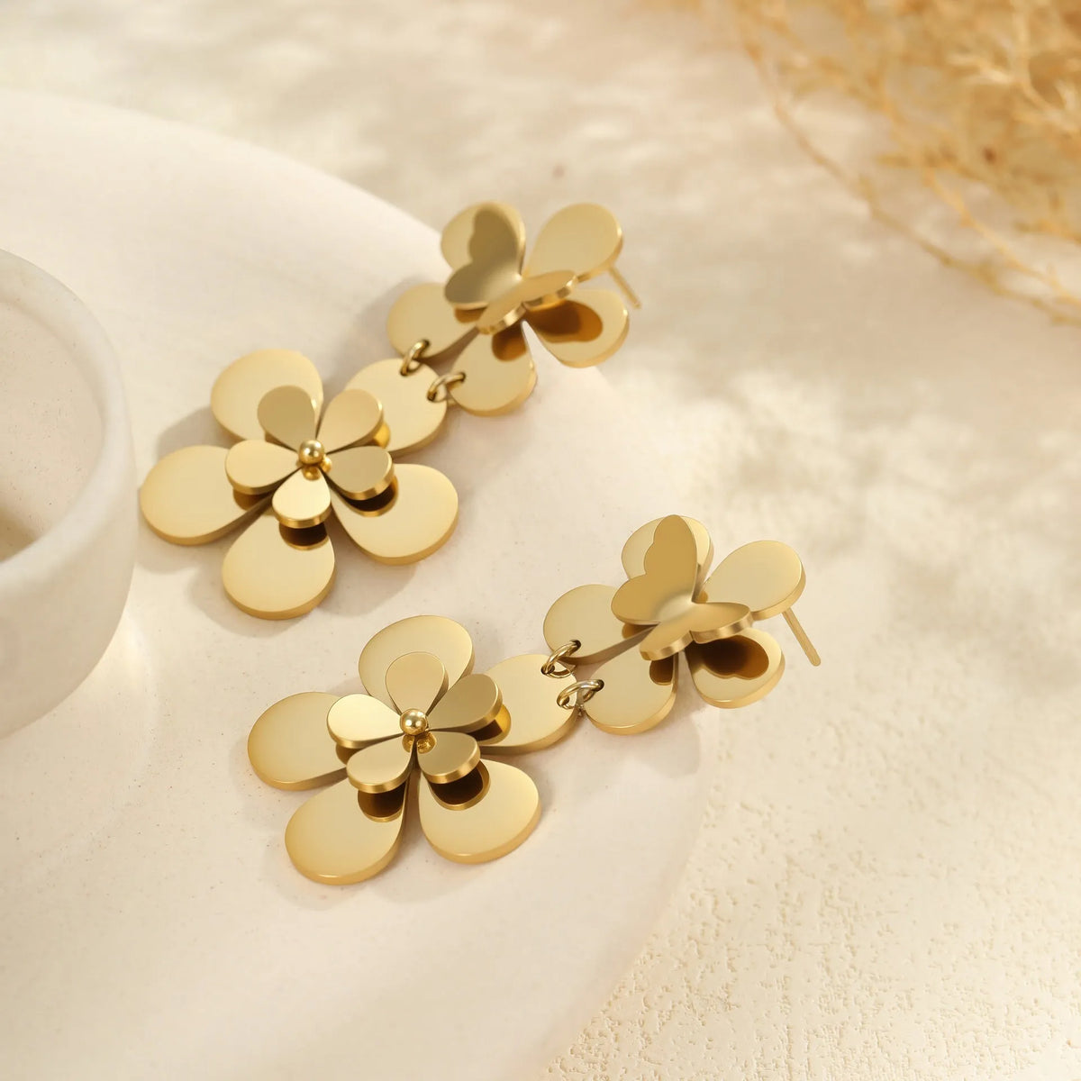 Gold electroplated stainless steel women's earrings with floral butterfly design