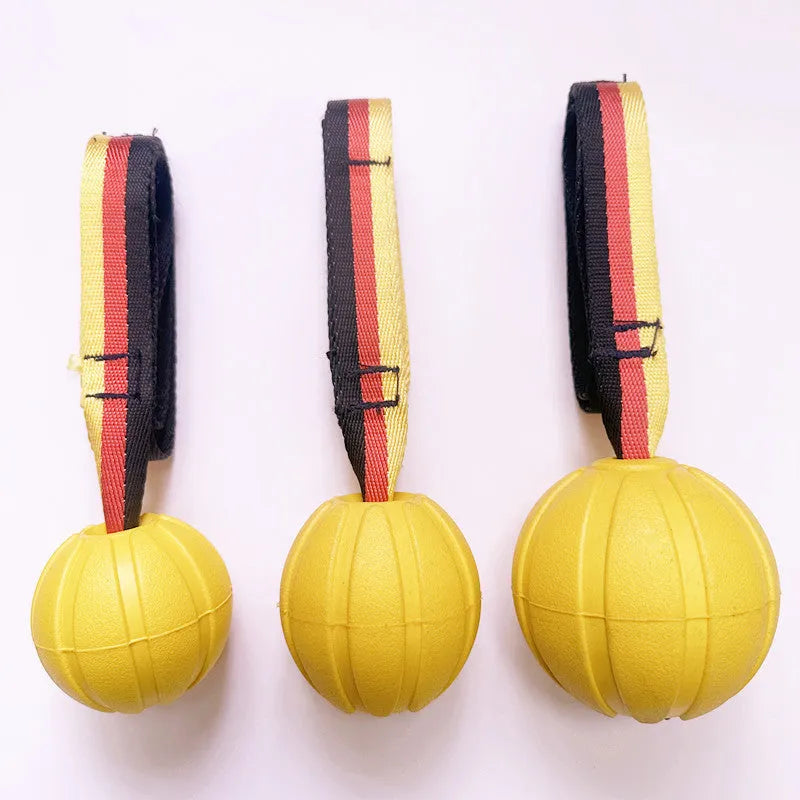 Yellow and camouflage coloured EVA floating dog chew balls in three different sizes on a blue background.