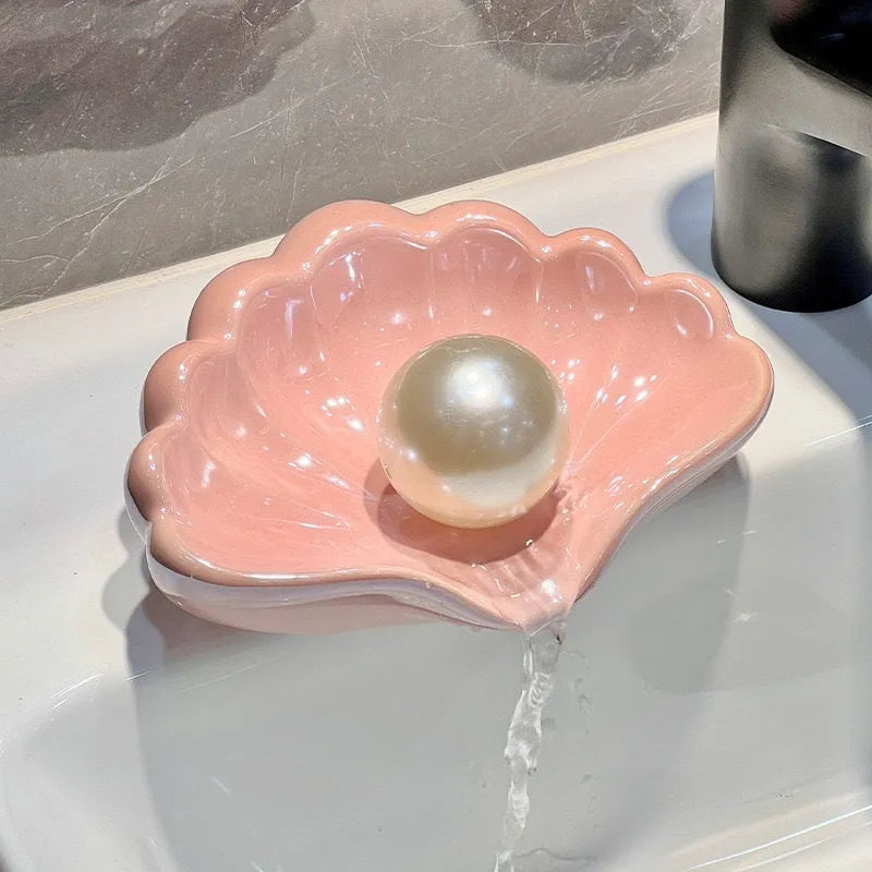 Shell-shaped white plastic soap dish with drainage for bathroom use