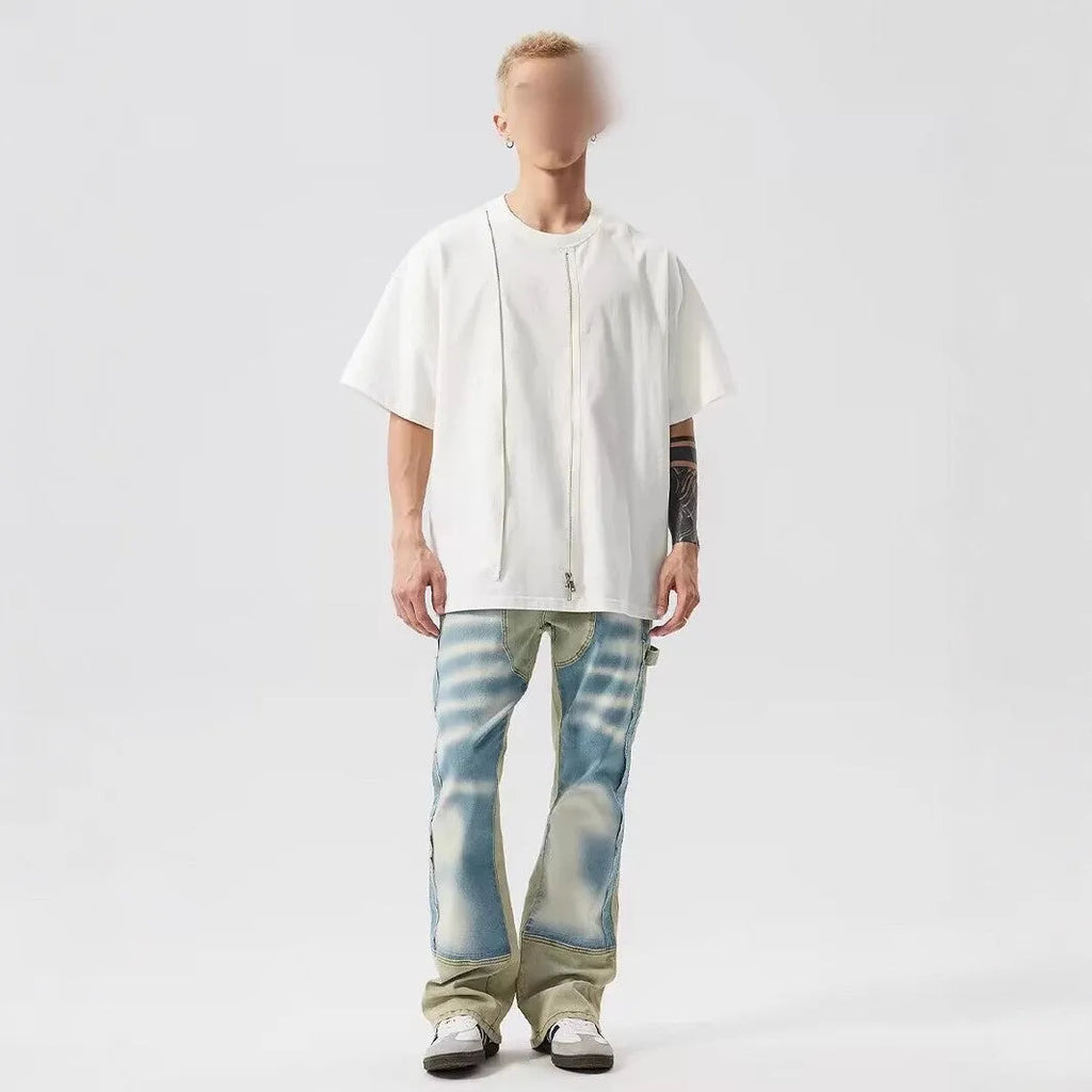 Yellow and blue patchwork jeans with a distressed splash-ink design on a mid-waist fit.
