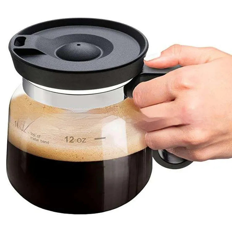 Transparent borosilicate glass coffee maker with a black silicone cover.