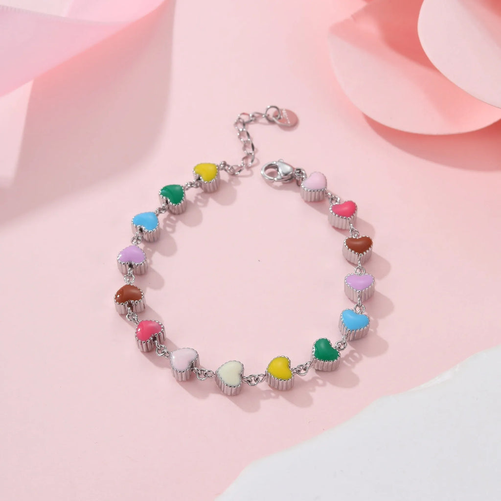 Women's heart-shaped stainless steel bracelet with 18K electroplated finish in gold or steel tone.