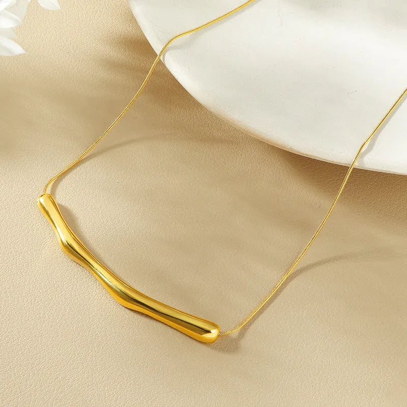 Women's titanium steel pleated necklace in gold tone with irregular textured finish.