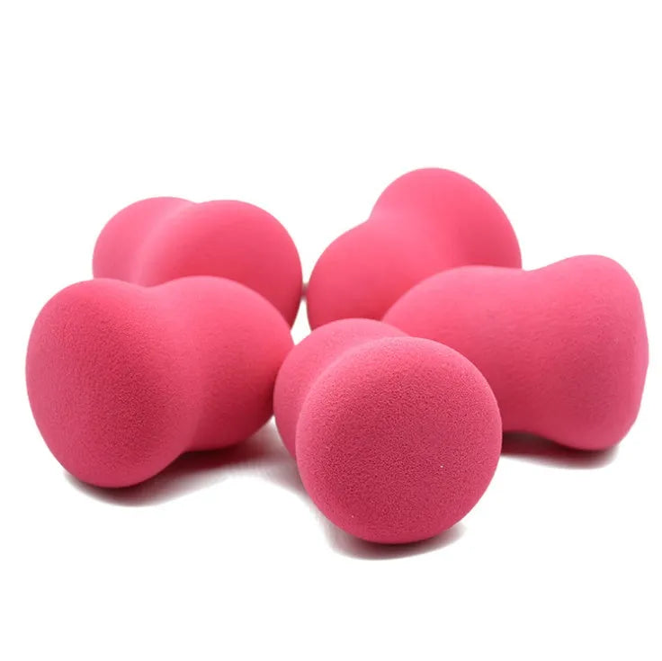 Pink makeup foundation sponge with chiselled edges for blending, shown next to a ruler showing 4cm width.