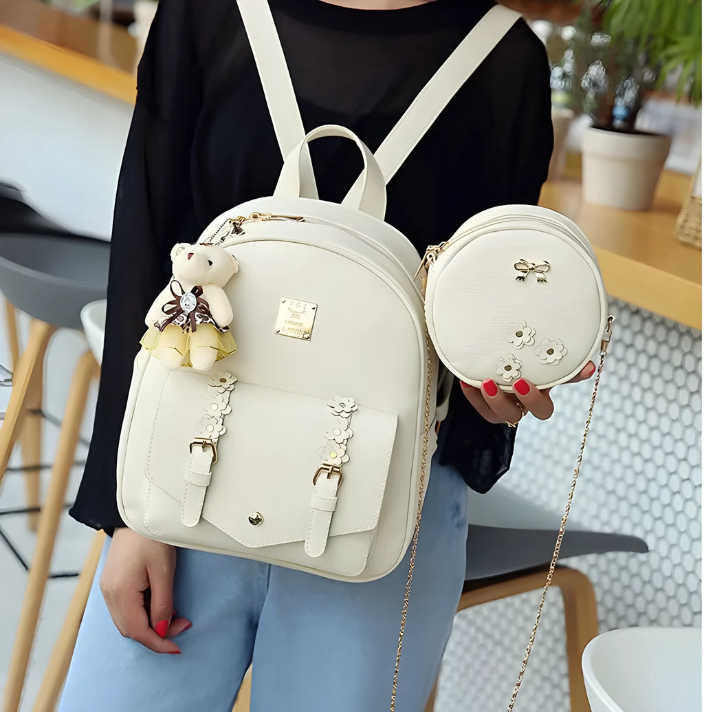Women's three-piece PU leather bag set showing backpack, shoulder bag and card holder in a floral design.