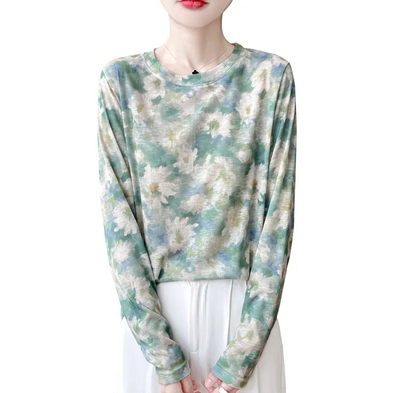 Floral print round neck pullover in knitted Tencel cotton fabric on a hanger.