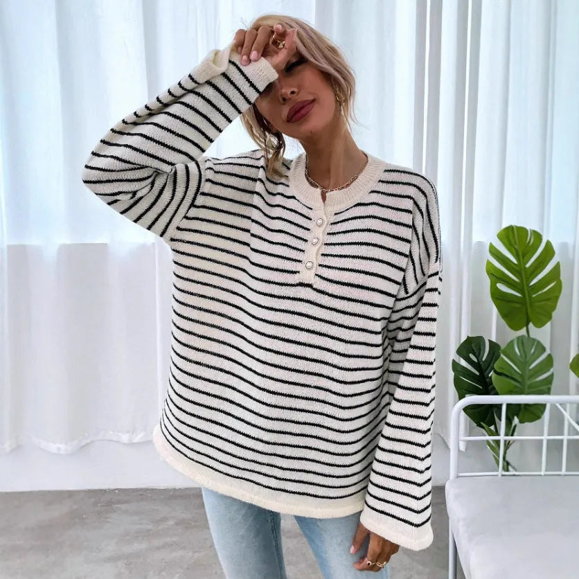 Black striped women's knitted top with drop shoulder sleeves on hanger