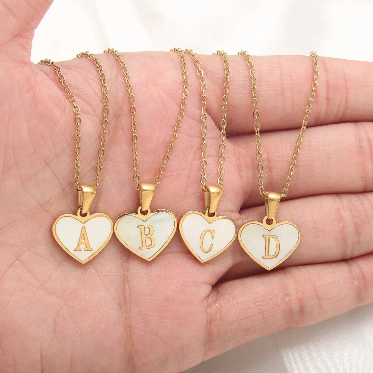 Gold-plated heart-shaped white shell necklace with adjustable chain and letter personalisation option