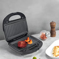 Black double-sided electric sandwich pan with stainless steel lid and non-stick coating.