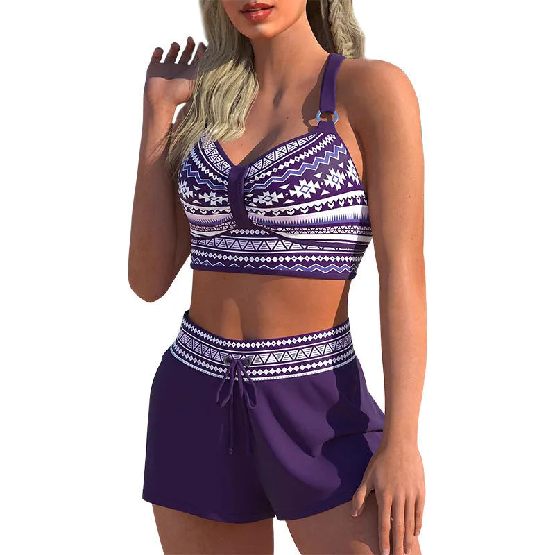 Women's navy blue and print polyester two-piece bikini swimsuit on a hanger.
