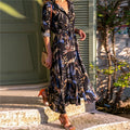 Women's black printed chiffon V-neck dress with an A-line skirt and conventional sleeves.