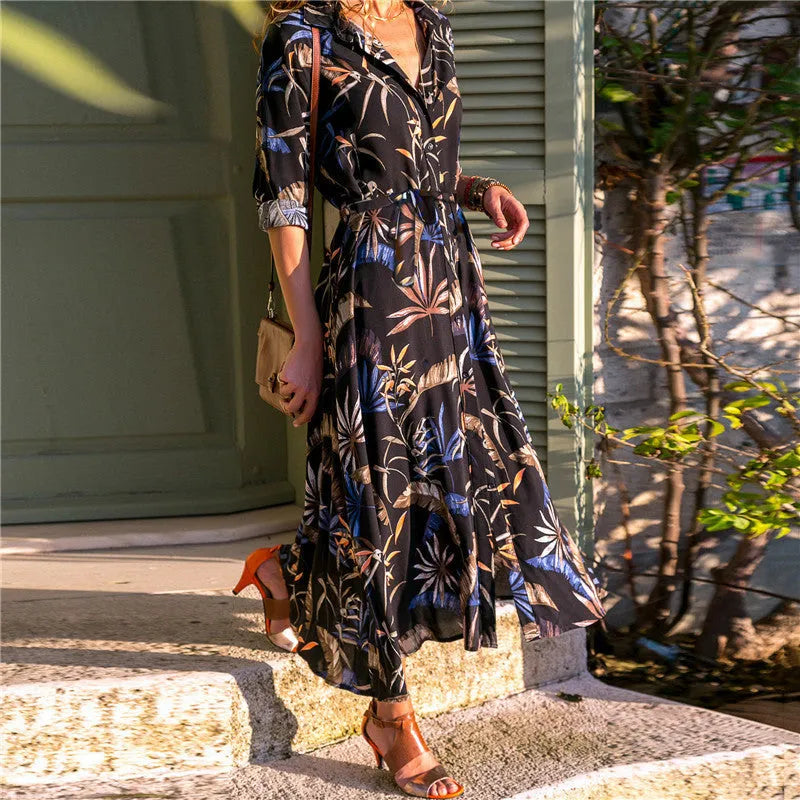 Women's black printed chiffon V-neck dress with an A-line skirt and conventional sleeves.