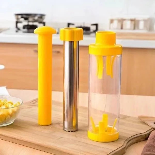 Yellow cylindrical corn stripper kitchen tool with stainless steel components on a kitchen worktop.