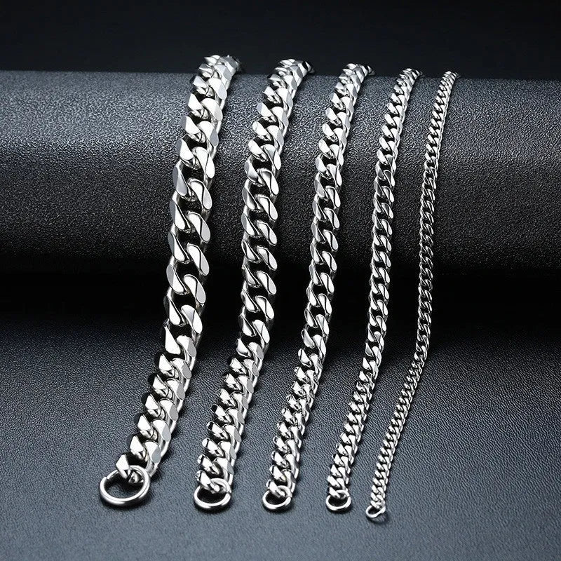 Geometric six-sided Cuban link metal bracelet in gold finish on a grey background.