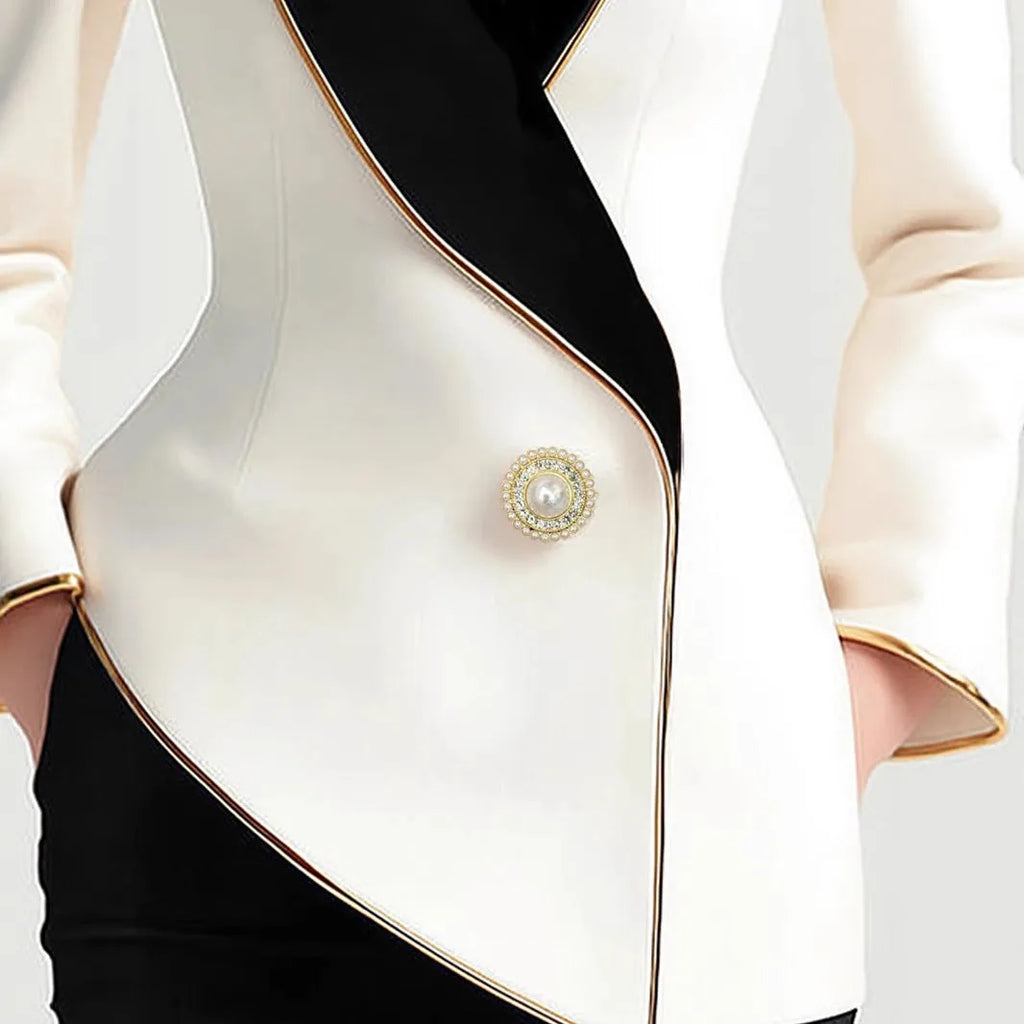 Women's beige long sleeve coat with irregular hemline and golden pearl buttons on a hanger.