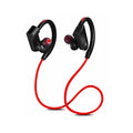 Black wireless neckband Bluetooth earphones with earbuds and a USB charging cable on a grey background.