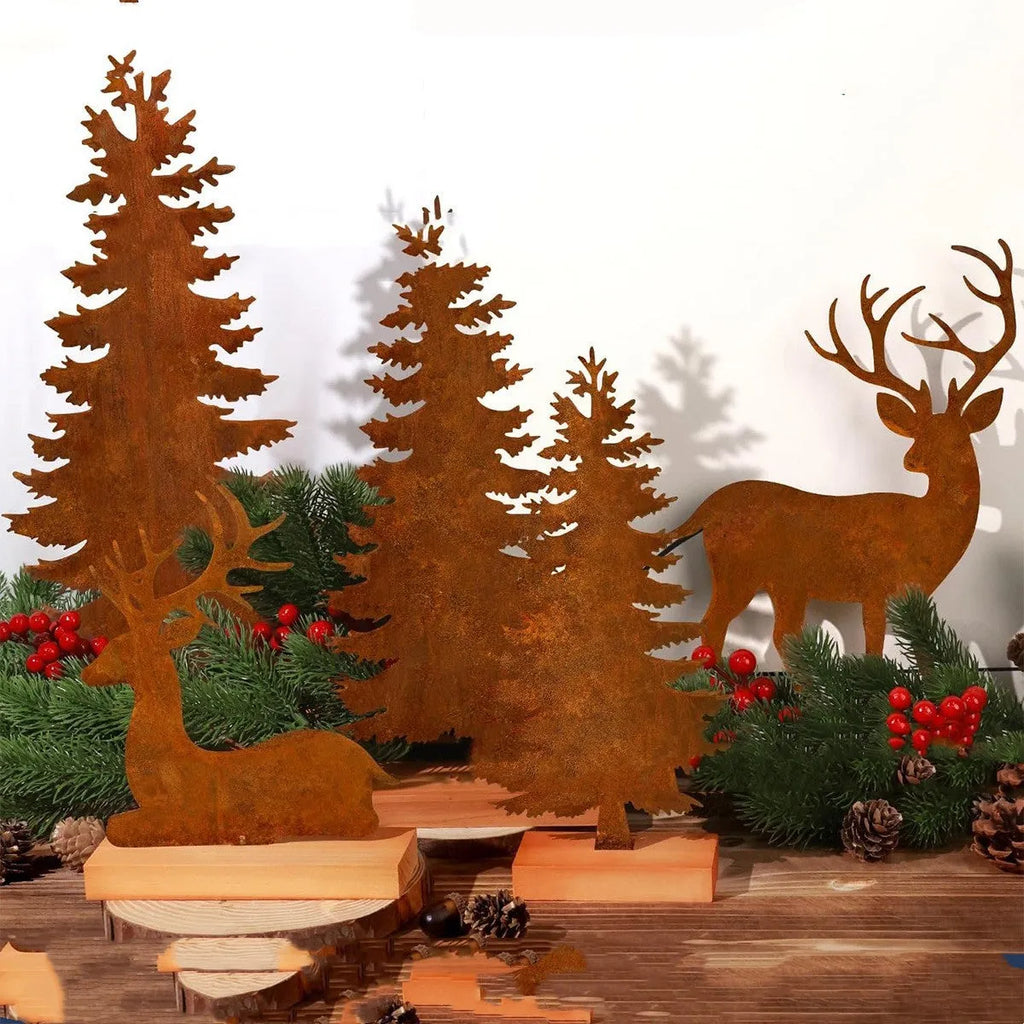 Three rusty metal Christmas decorations featuring elk and trees on a wooden surface