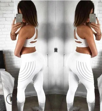 Women's black workout leggings with a glowing print, shown in a slim-fit pencil pants style.