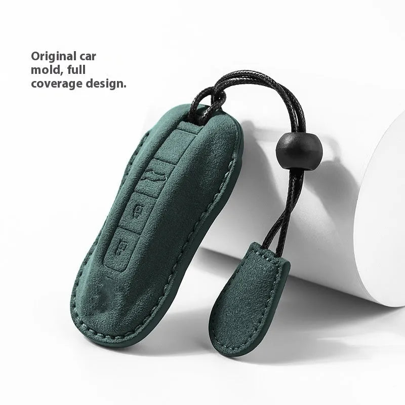 Suede car key cover shown in Cement Gray, Dark Green, Light Gray, and Orange colour options.