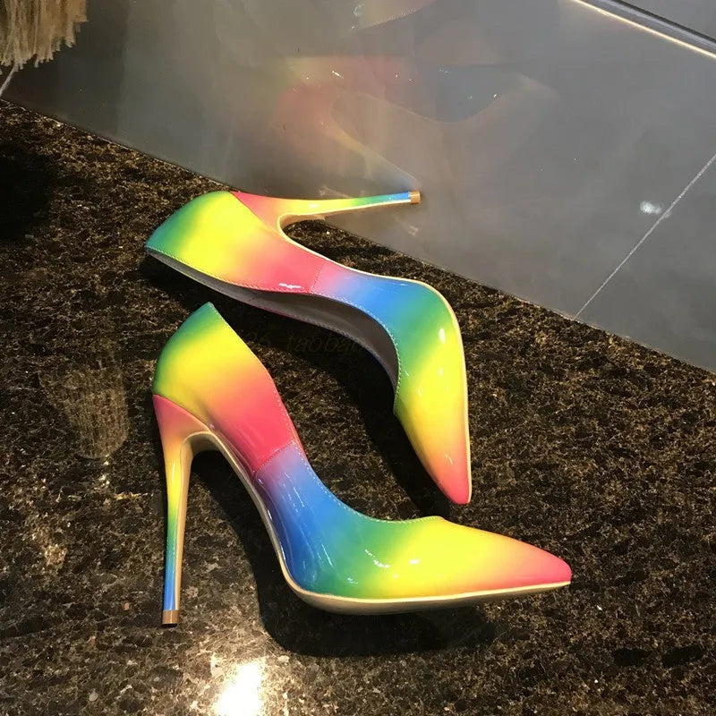 Rainbow patent leather pointed toe stiletto heels with thin ultra-high heel on white background