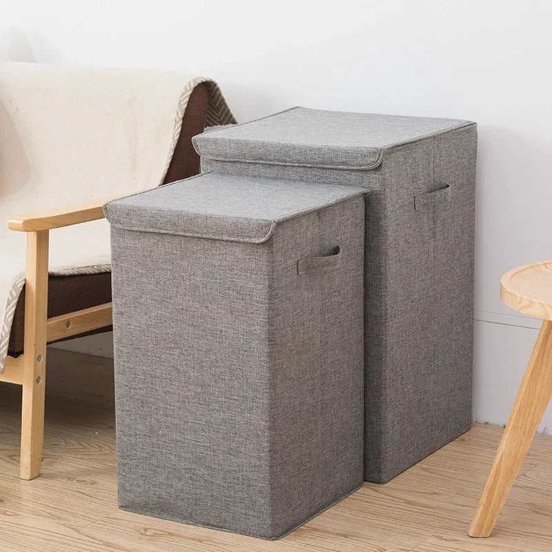Foldable cotton linen storage basket in grey, shown in a modern room holding clothes and books.