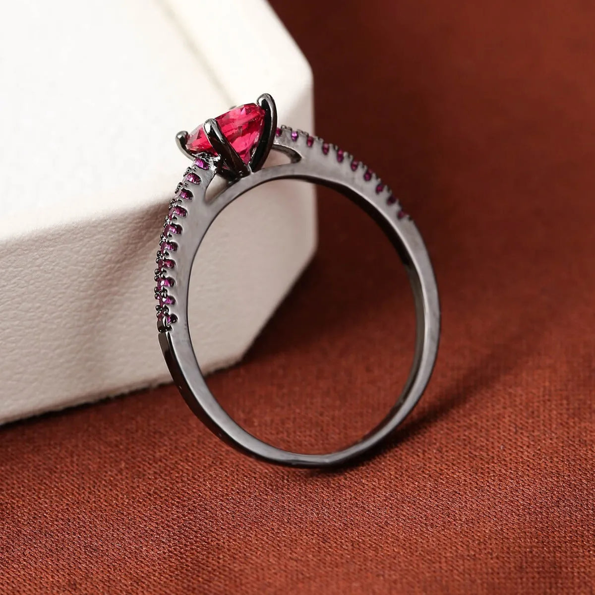 A hexagonal geometric zircon ring in a copper electroplated finish, showing one of the ten available colour options.