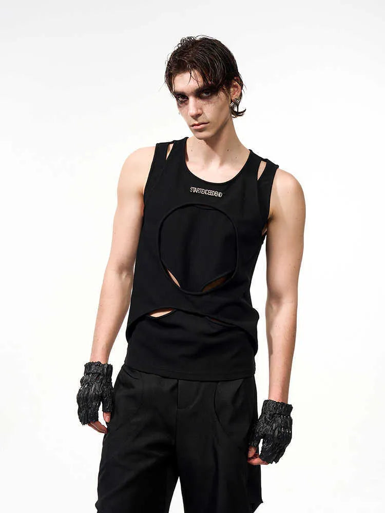 Man wearing a black sleeveless waistcoat with hollow white thread detail and a round neck.