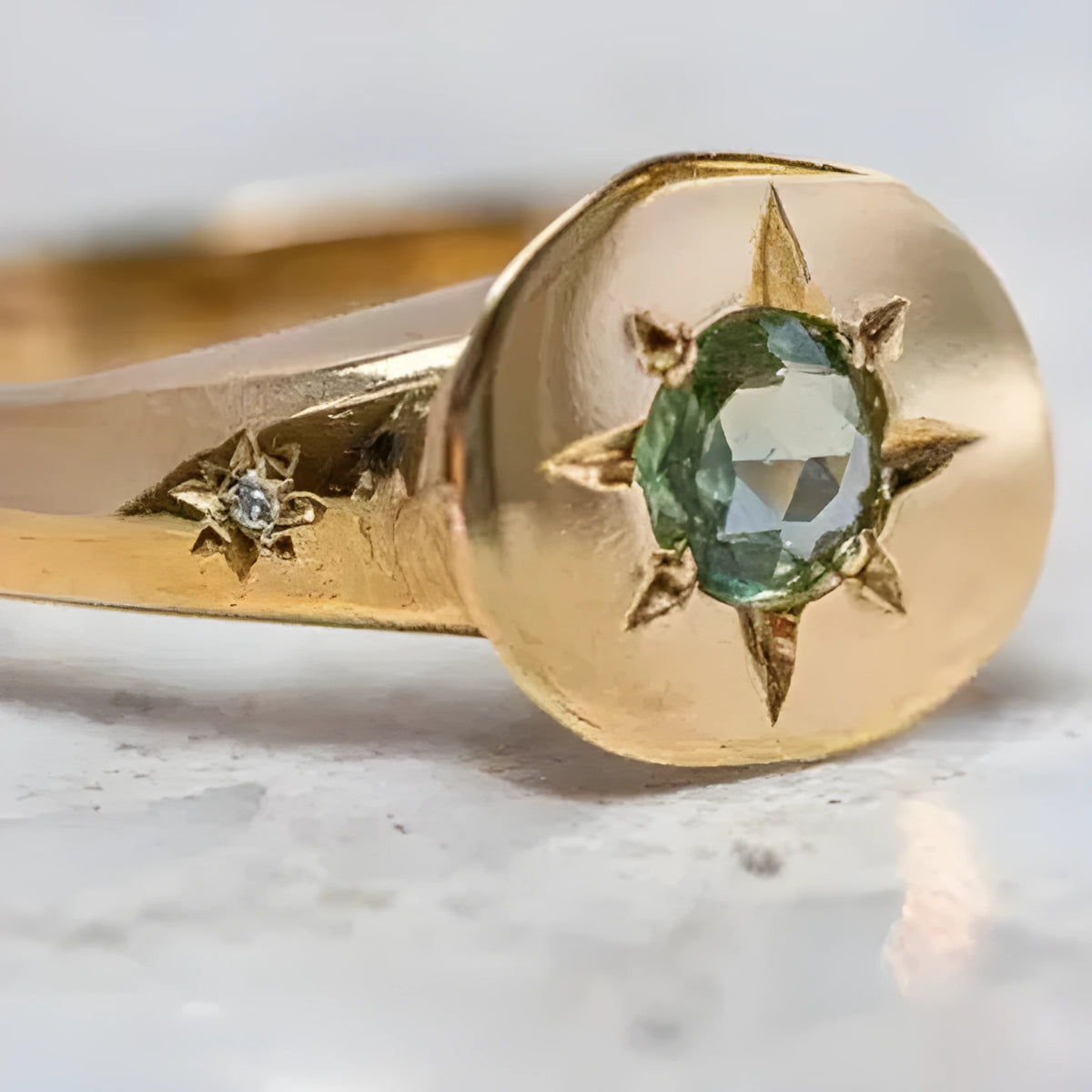 Gold coloured adjustable opening ring with star-shaped zircon design and oval profile