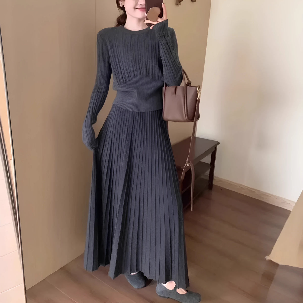 Dark grey knitted ethnic style dress suit with collage stitching, featuring a sweater and skirt.