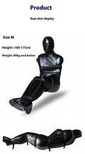 Black patent leather bondage set showing full body wrap and six ratchet tie-down straps arranged together