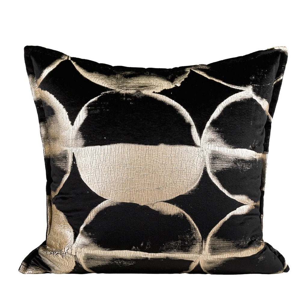 Black and gold abstract pattern square cushion with removable feather velvet cover on a sofa.