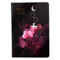 A5 notebook with a luminous cover open to show pages with colour illustrations, in deep blue, gold, light blue, or purple.