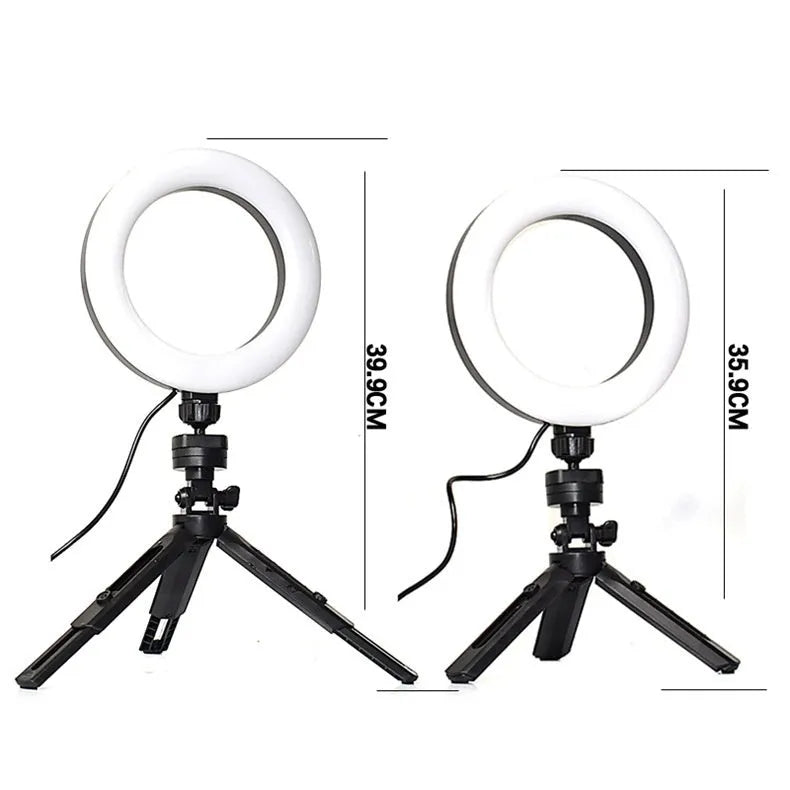 Black mobile phone video bracket with adjustable fill light mounted on a desktop tripod.