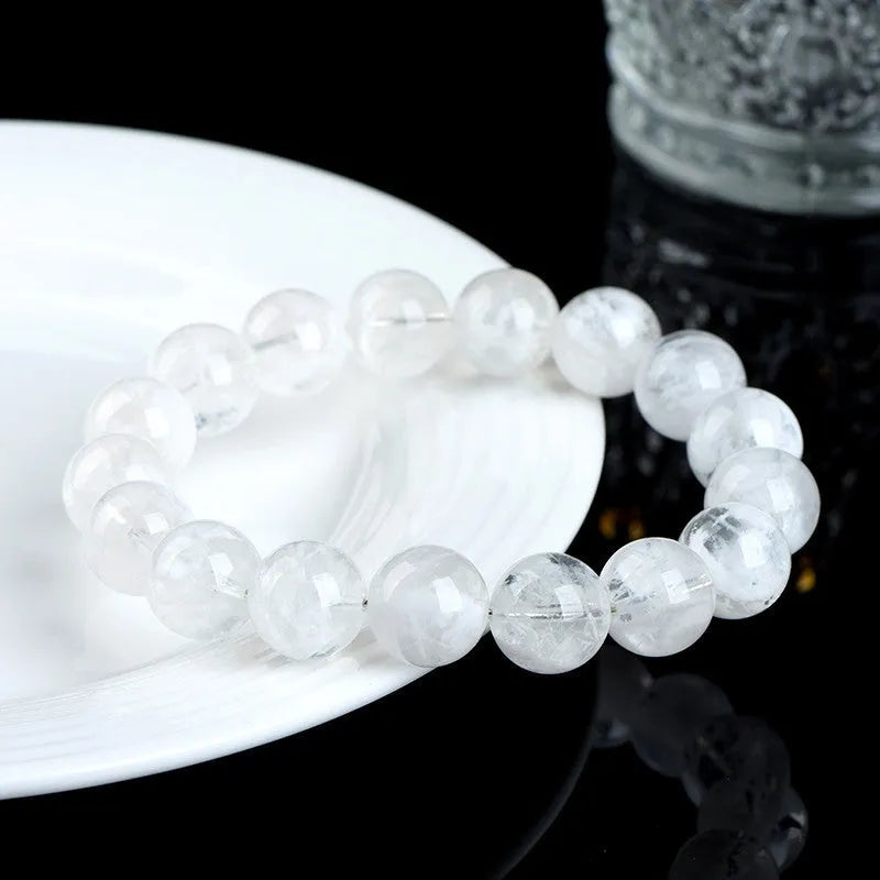 Women's crystal bracelet with round blizzard snowflake beads and ruyi xiangyun charm.