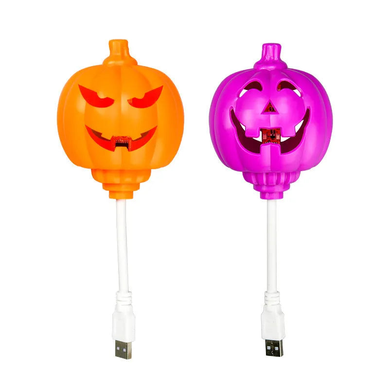 Plastic pumpkin-shaped USB rechargeable lamp glowing with either yellow or purple light, measuring 22cm tall.