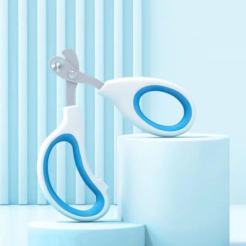 Blue cat nail clippers with circular cutting hole and cushioned handle on a white surface.