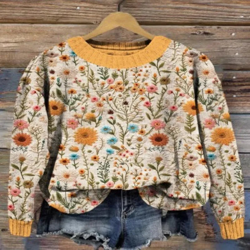 Women's grey round neck sweater with a small white digital flower print pattern.
