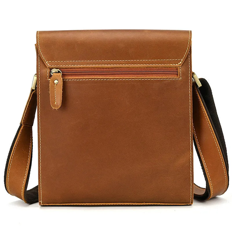 Men's brown cowhide leather crossbody bag with flip shoulder strap and retro style.