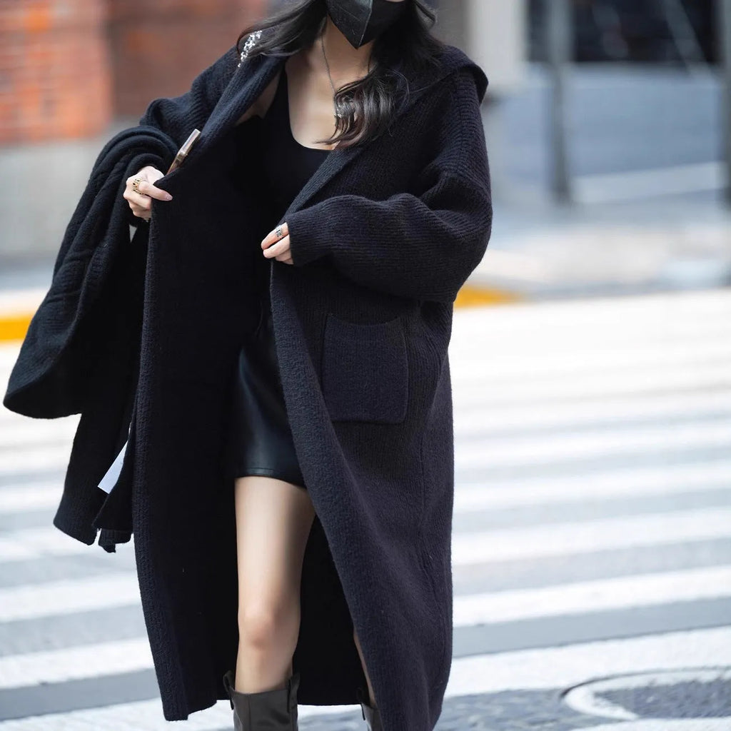 Long grey knitted cardigan with hood in trench coat style, showing wool blend fabric texture and 80cm length